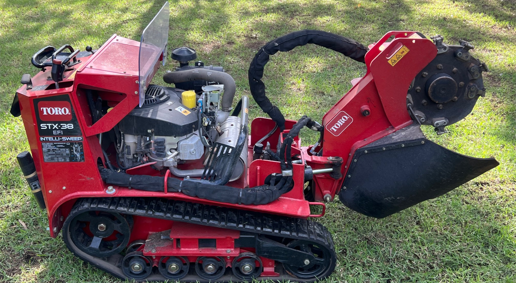 Stump Grinding Services by Coastwide Contracting, Newcastle, Hunter Valley, Port Stephens, Mid North Coast. Red Tora Stump Grinder. Tree Stump Removal. Cleared Tree Stump in Garden. Affordable tree stump removal. Commercial and residential stump grinding and removal.